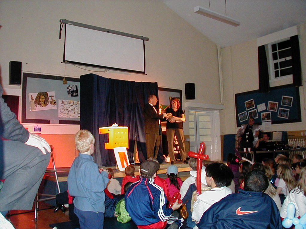 Colin Perrotton making the children laugh at a PTA fundraiser